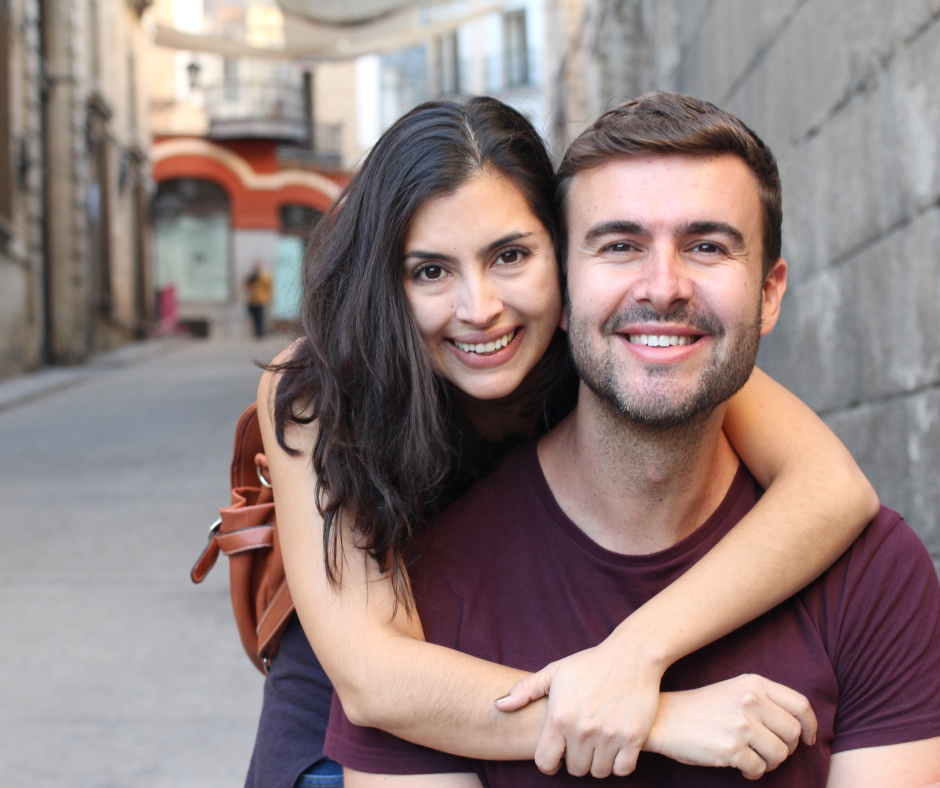 American man takes picture with foreign lady.